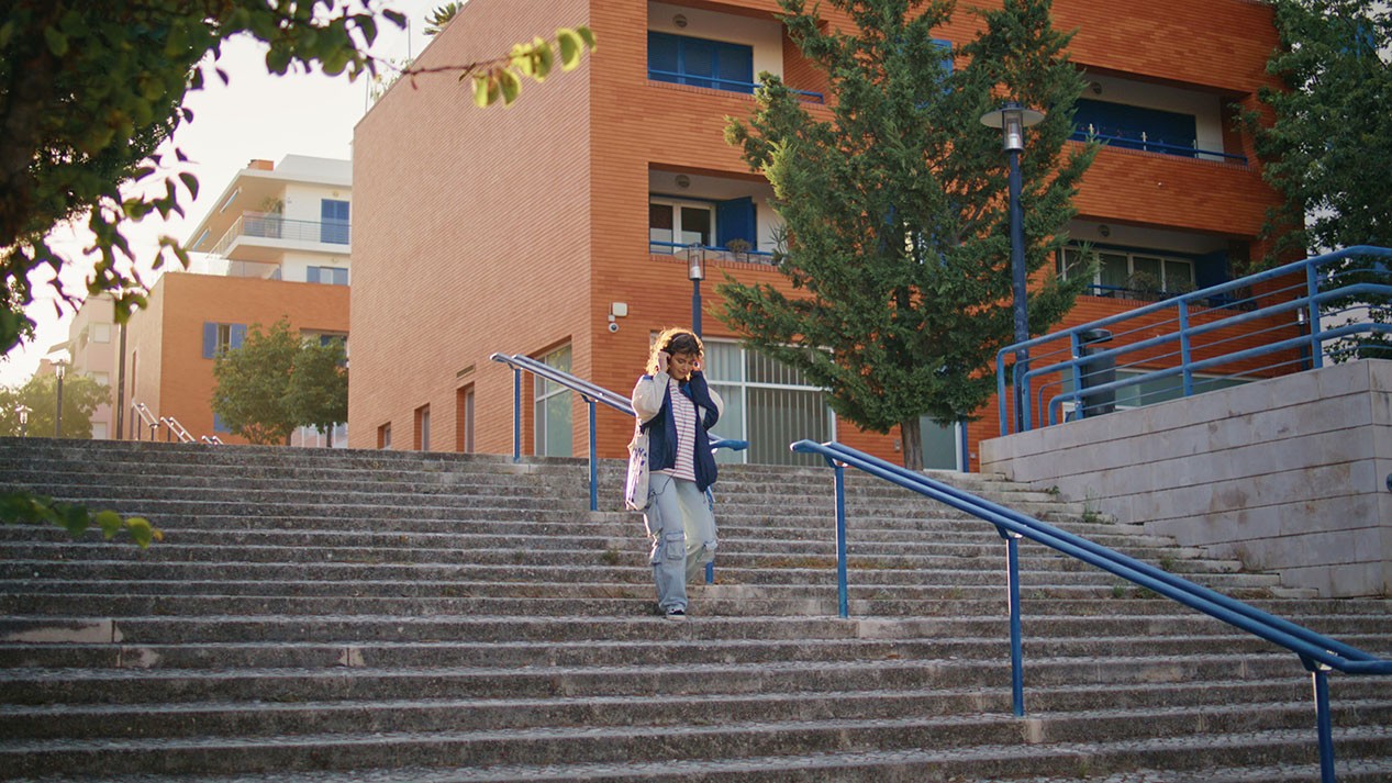 tourist-walking-down-stairs-evening-sunlight-woman-exploring-urban-district