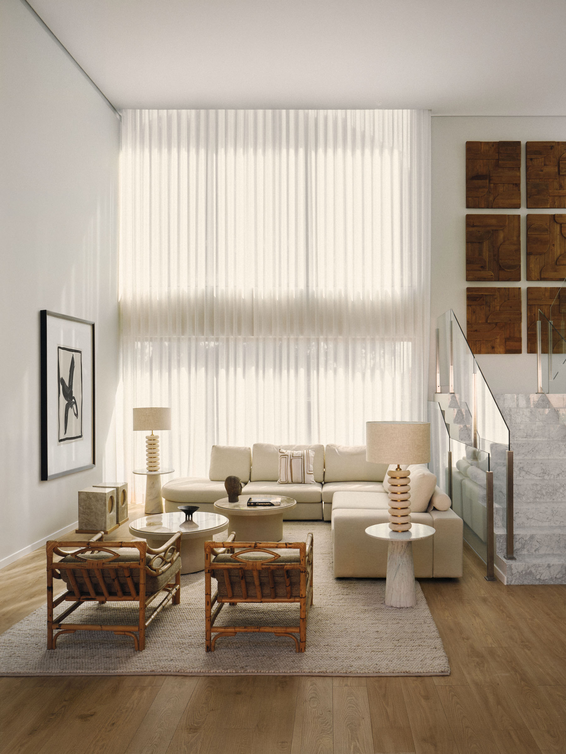 Living room with vintage furniture and large windows in an Estoril house by Raúl Martins