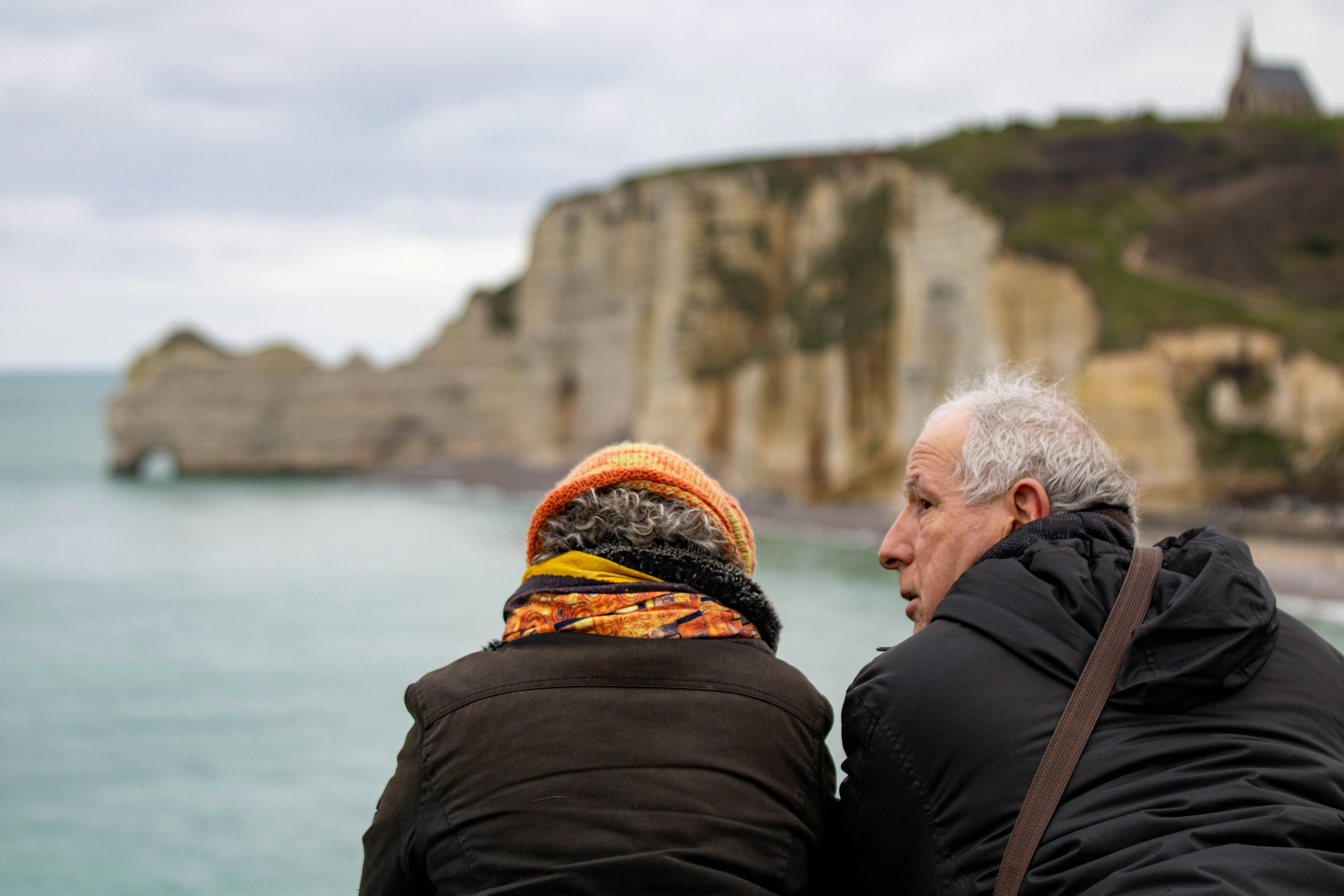 A couple of people that are looking at the water