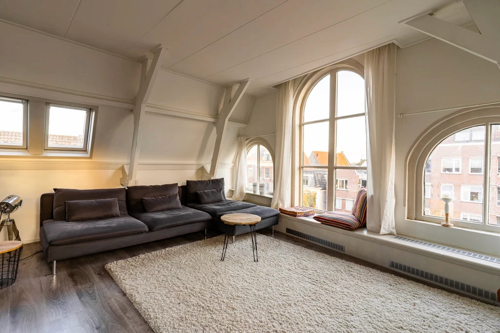 Living room with arched windows and a leather sofa