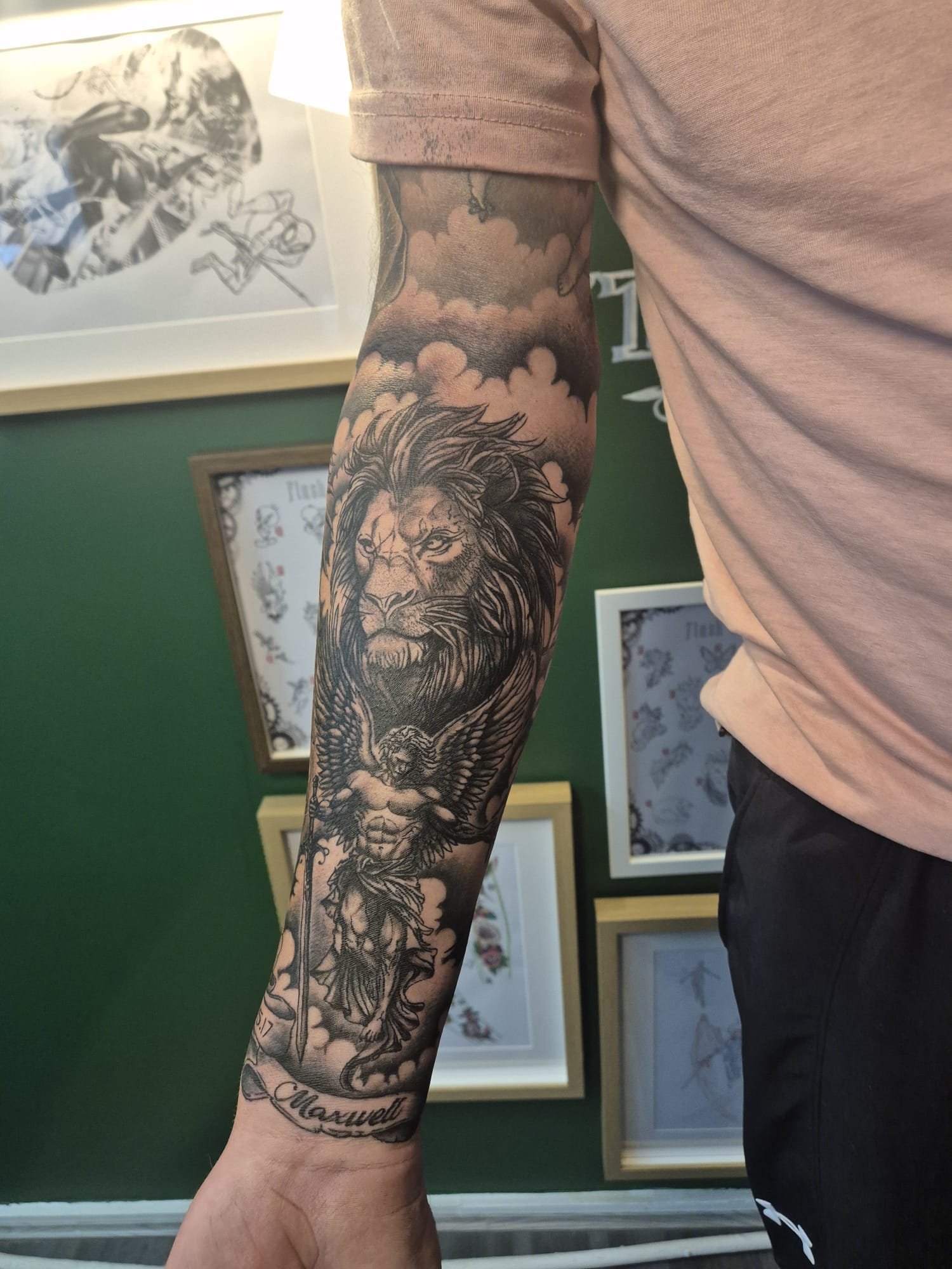 Black and grey forearm tattoo of warrior helmet in Hazel Grove