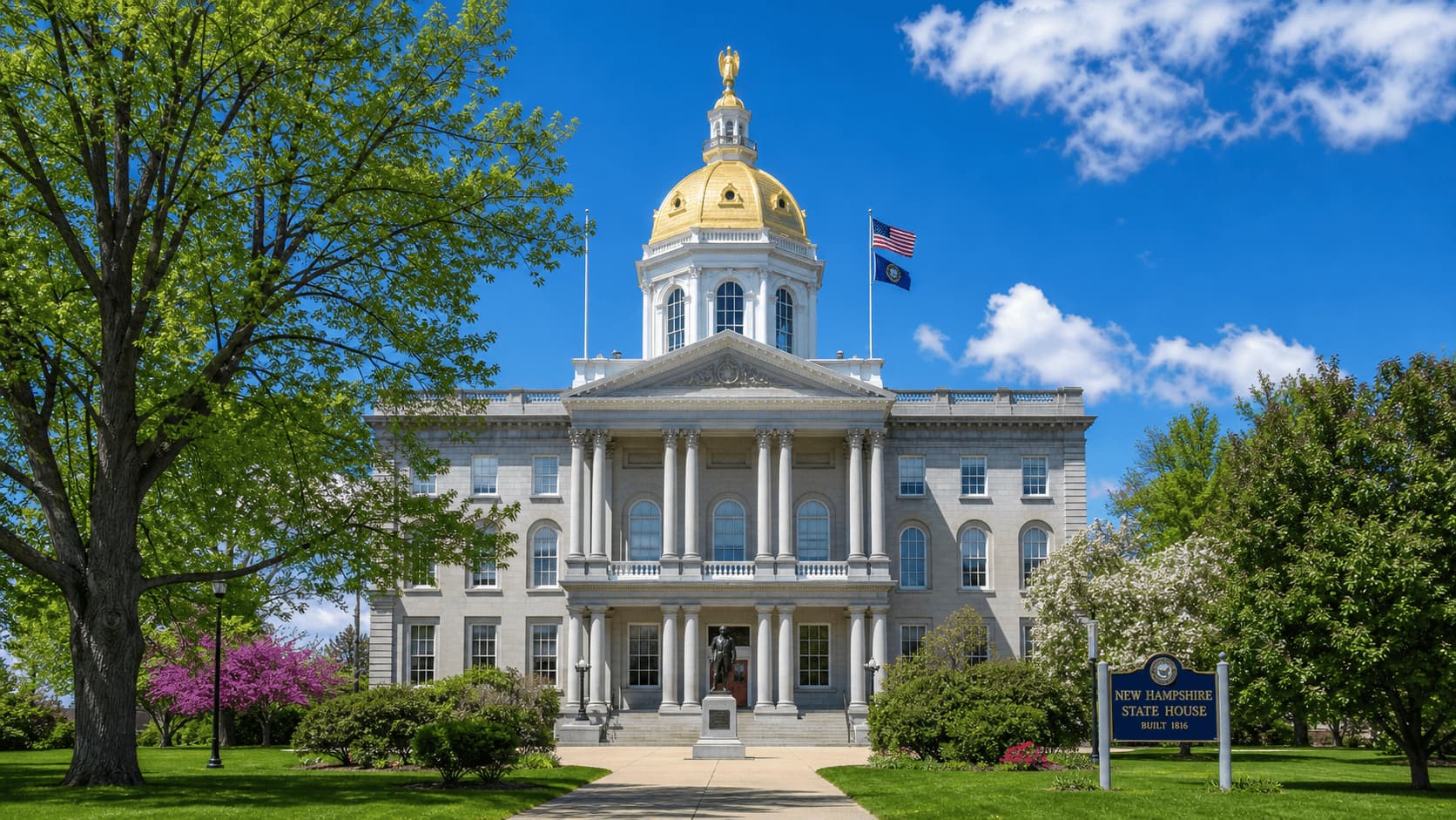 New Hampshire State House in Concord with gold dome and trees