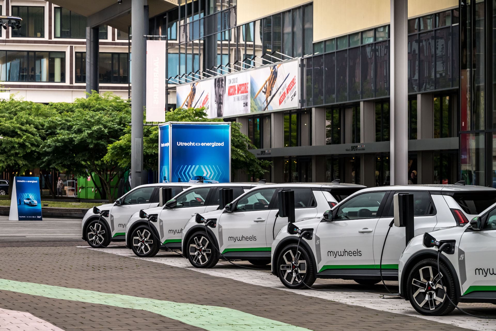 Five mywheels cars in a row on a street