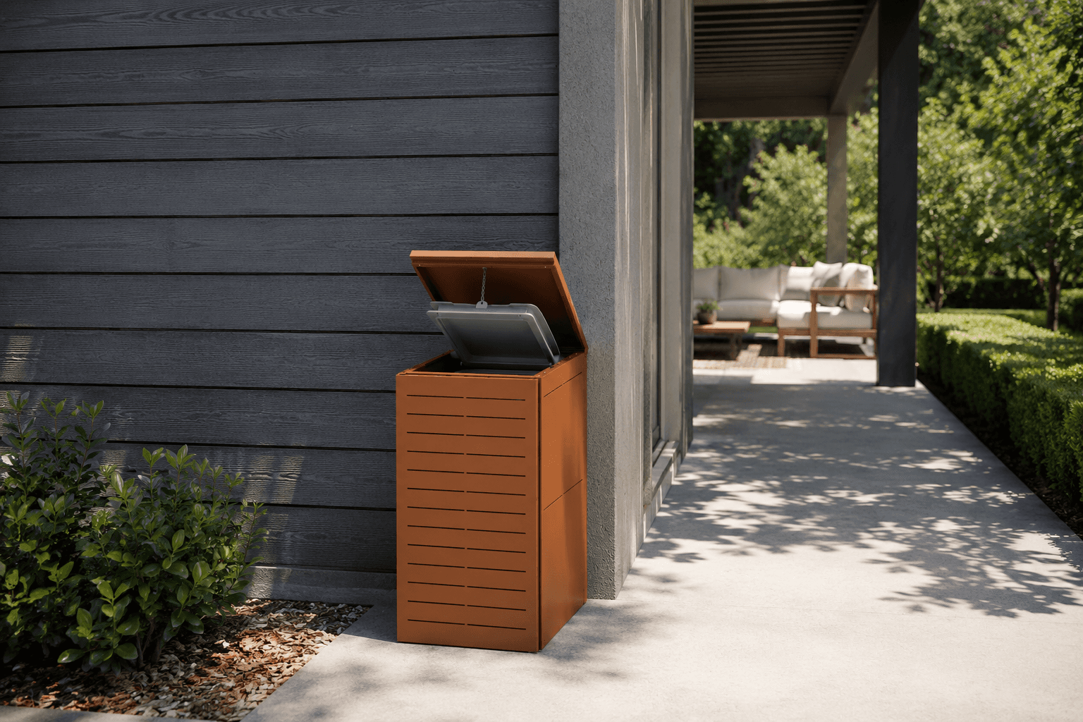 BinBox in acciaio corten installato in un patio esterno con giardino