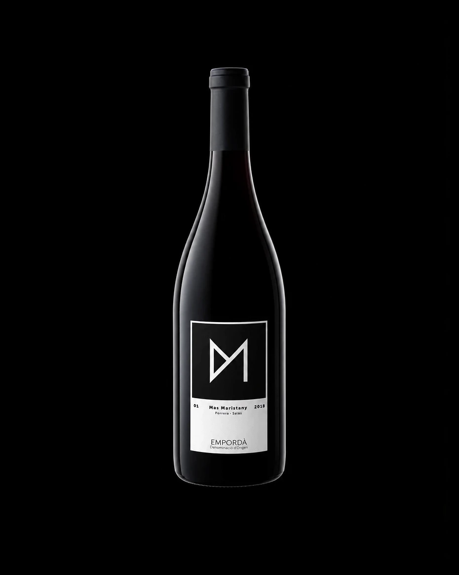 Mas Maristany wine bottle with a black-and-white label on black, brand identity design by Sebastian Saavedra