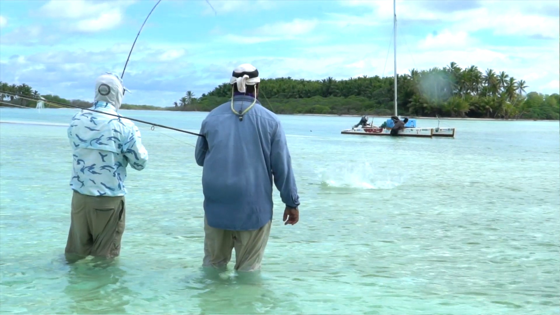 woman holding a phone and man looking at the phone. both are smiling