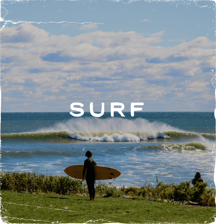 Rustic photograph of someone carrying a surfboard on the coast line with a large wave in the distance labeled 'Surf'