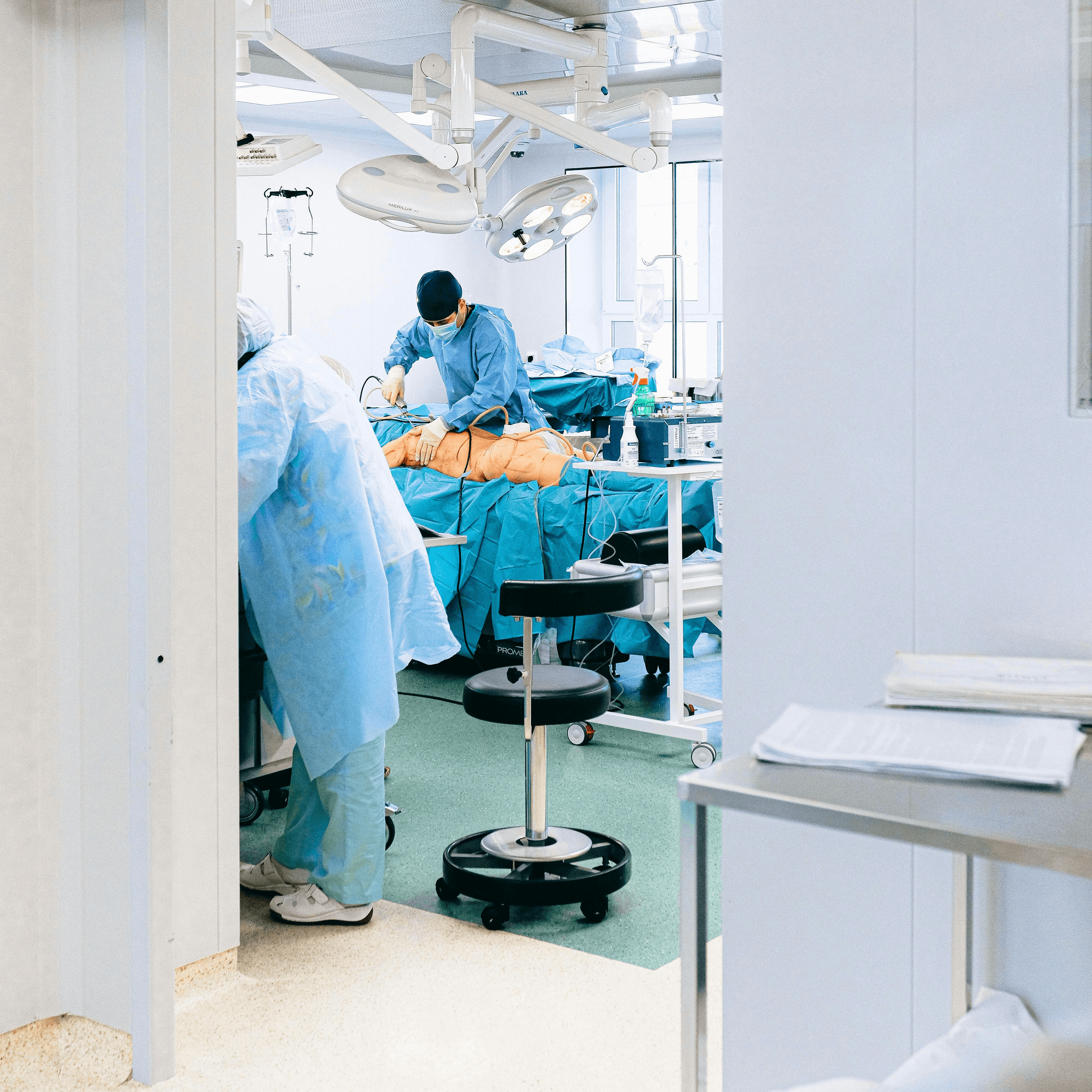 An anesthesia provider prepares equipment in an ambulatory surgery center operating room