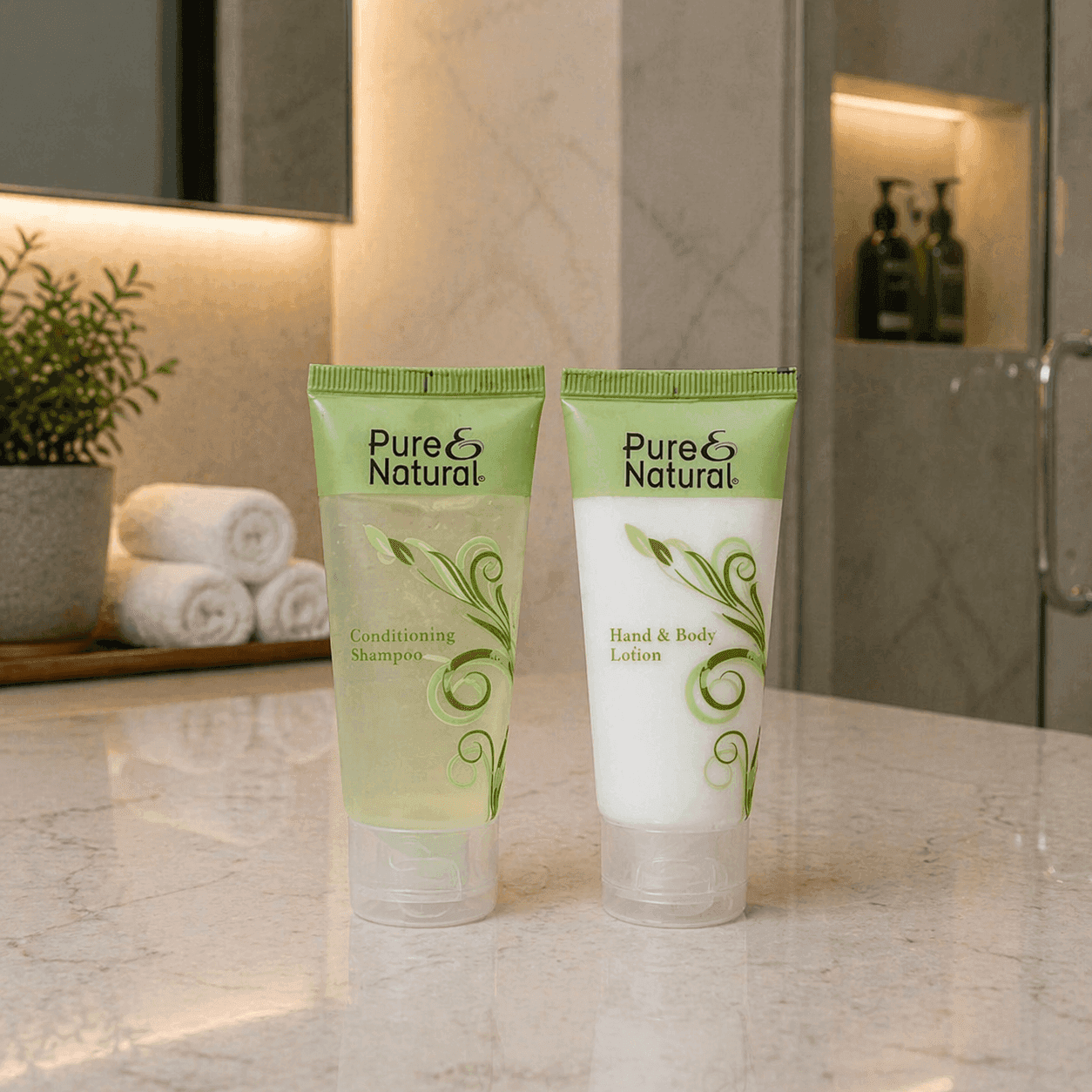 Pure & Natural shampoo and body lotion by Transmacro Amenities displayed on towel in a hotel bathroom setting
