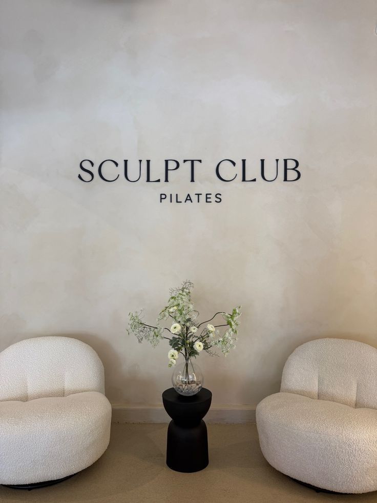 Metal Sign called Sculpt Club Pilates Studio in reception 