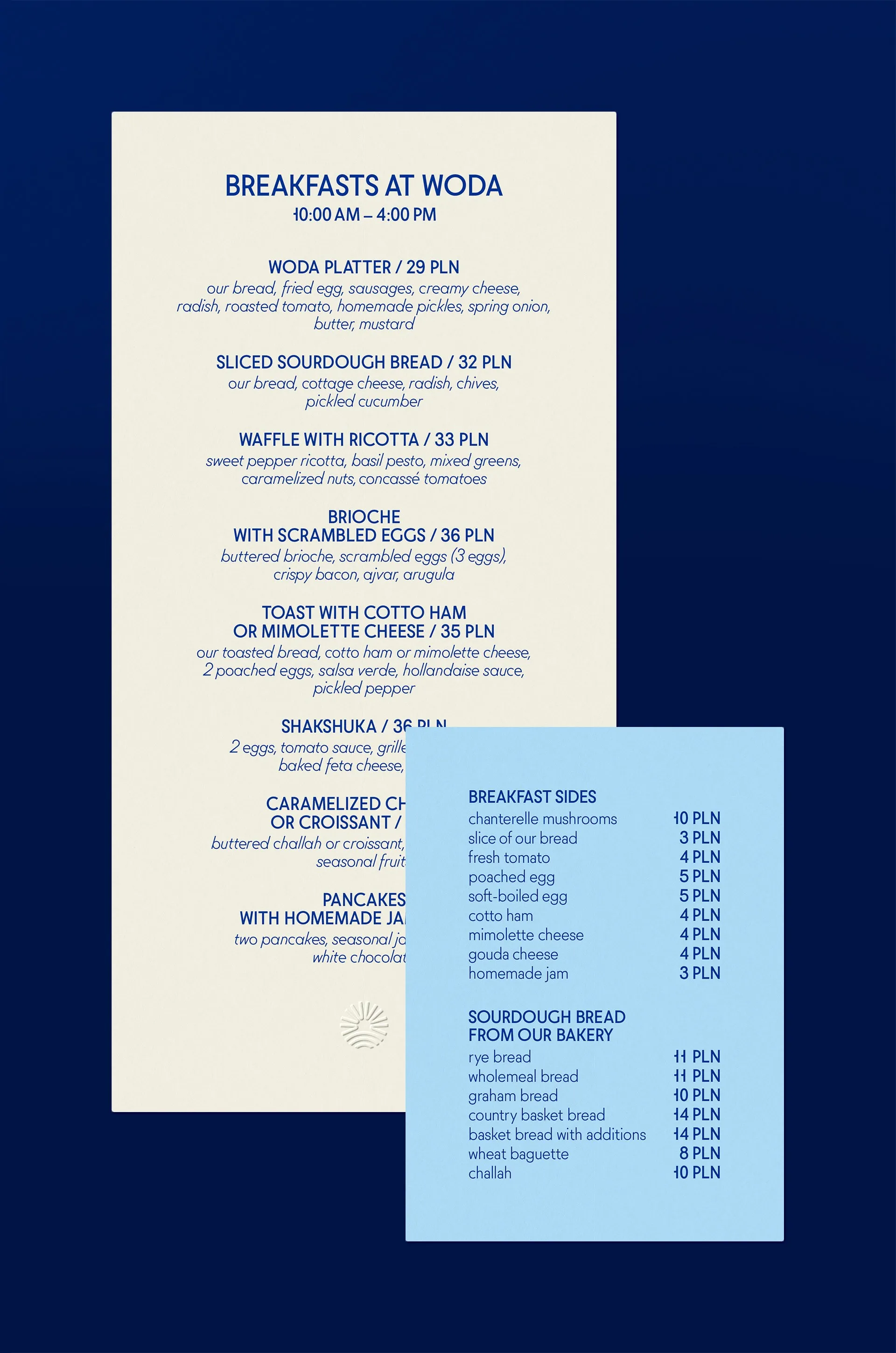 Cream daytime and blue nighttime Woda menu covers with the tagline Sip, savor, stay and cutlery, menu design