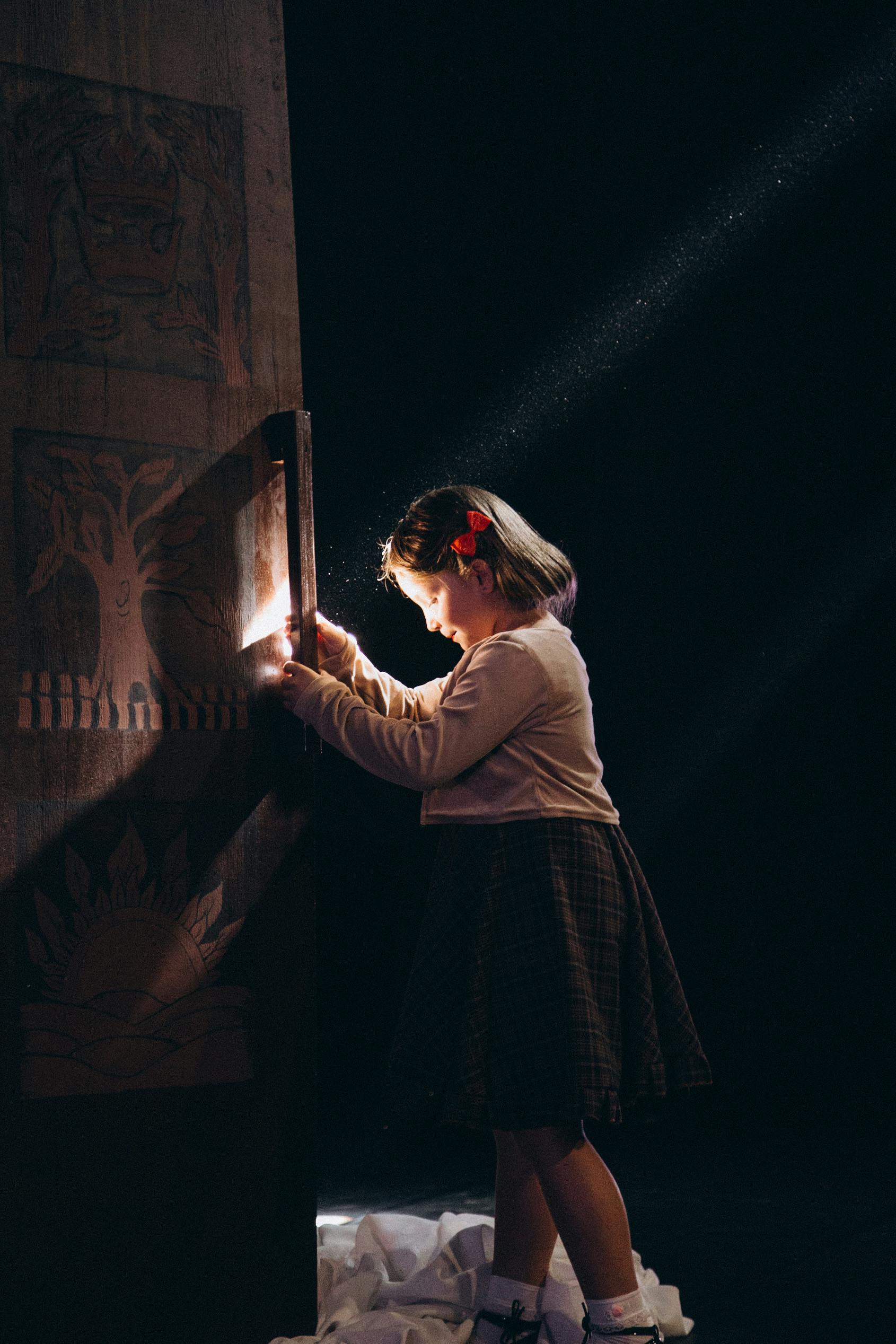 a child enjoying an mystery escape room with a curious expression