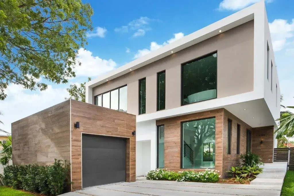 Street view of modern two-story home with wood cladding and garage on Alton Road Miami Beach by Atelier International LLC