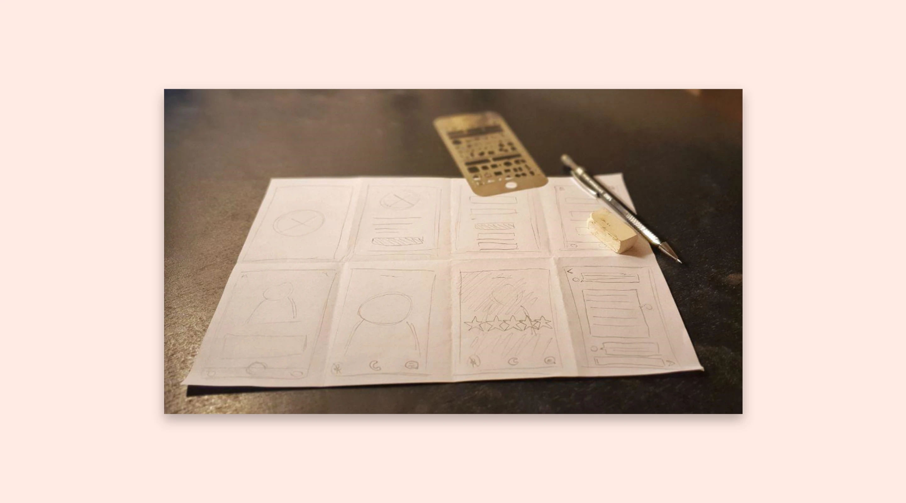 Paper sketch wireframes showing mobile navigation flow during project ideation phase