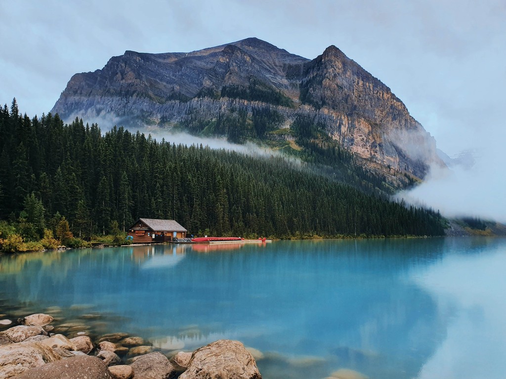 A mountain next to a lake