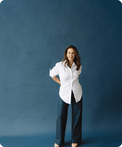 Stacy confidentially standing with her hands on her hips.