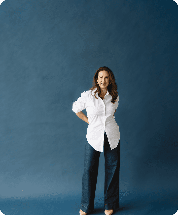 Stacy confidentially standing with her hands on her hips.