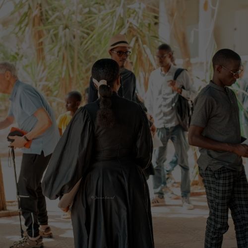 a group of children sitting on steps in front of a building
