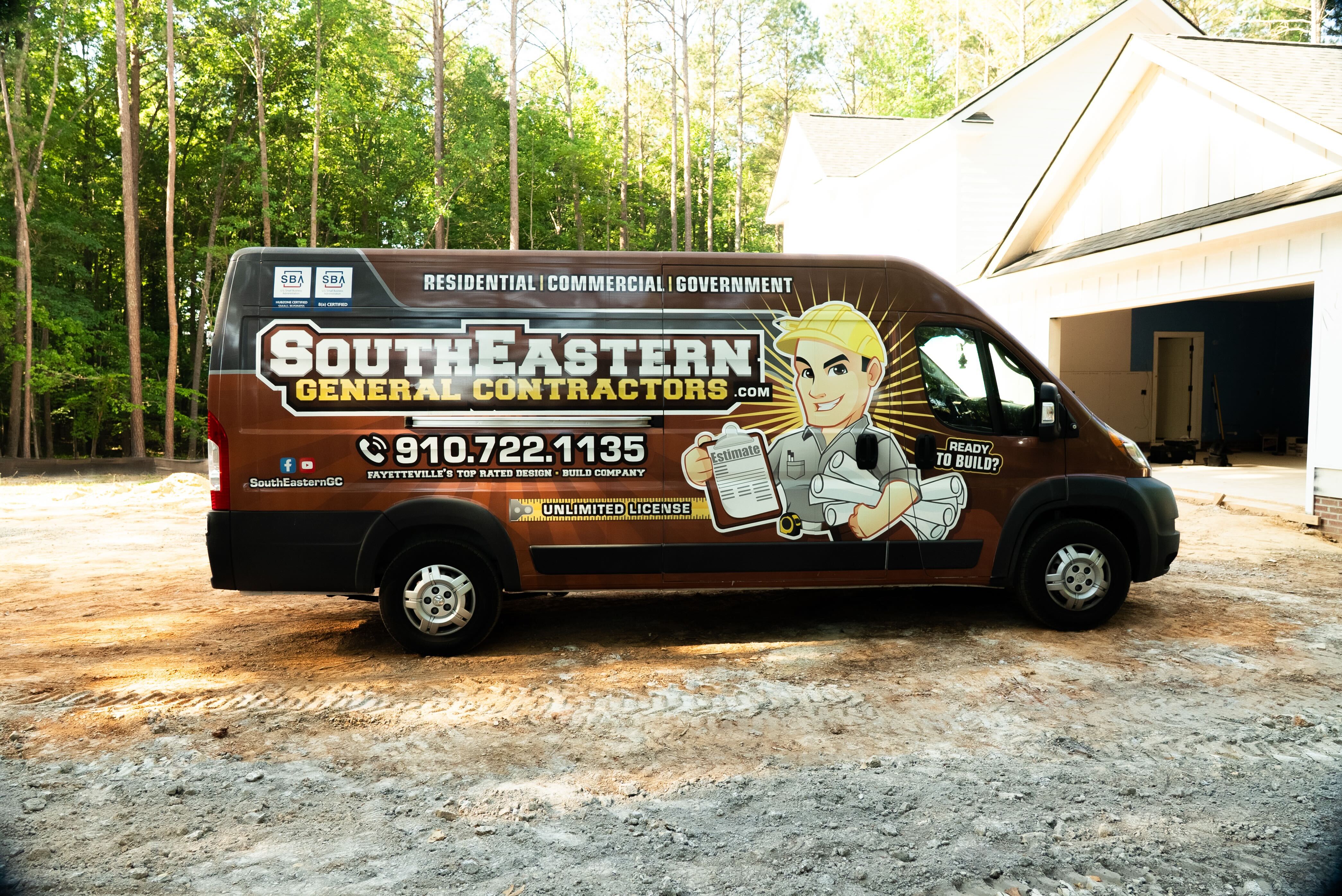 SEGC crew member on JLG lift performing professional caulking and painting on HardiePlank board-and-batten siding installation