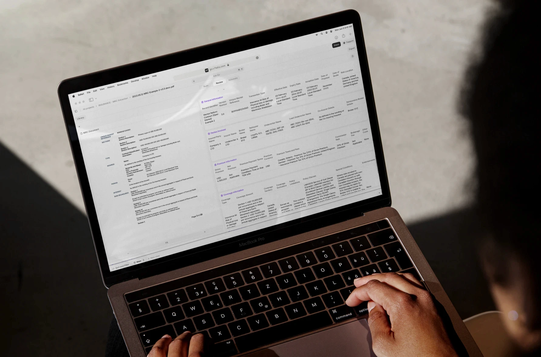 Laptop displaying insurance document with financial data.