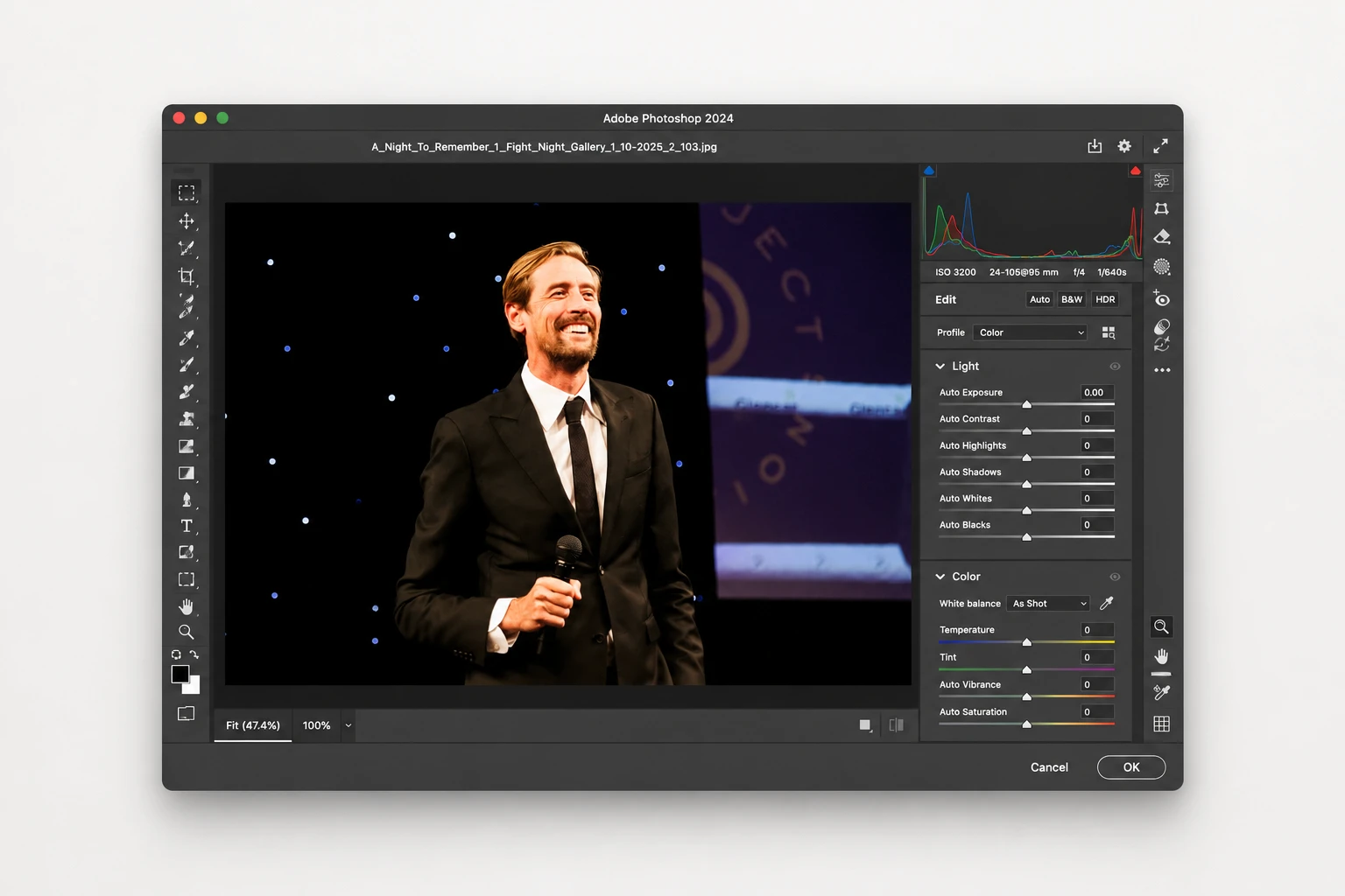 Man in suit holding microphone in Photoshop