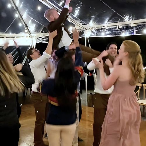 Excited wedding guests dancing the night away at a Collingwood reception, with the DJ playing a mix of classic and contemporary songs.