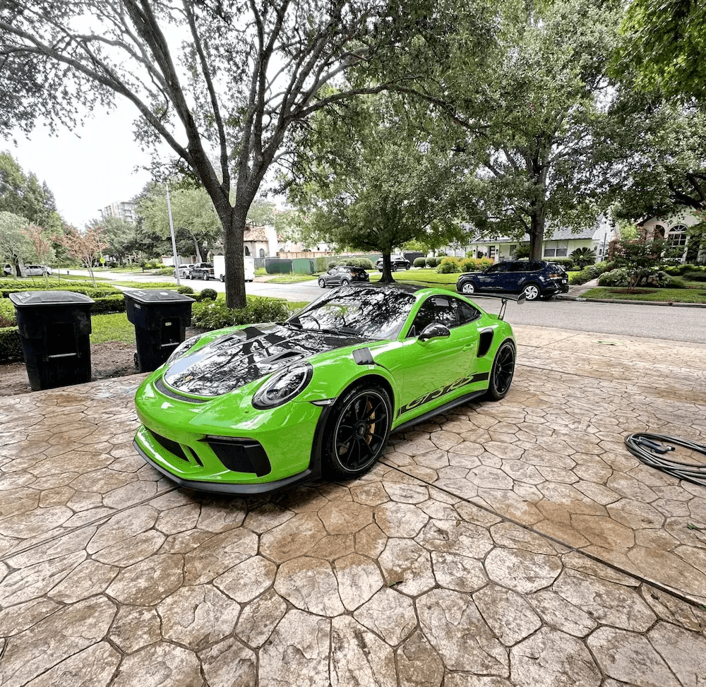 Reflective mirror shine on a luxury sports car protected by professional ceramic coating in Houston, TX.