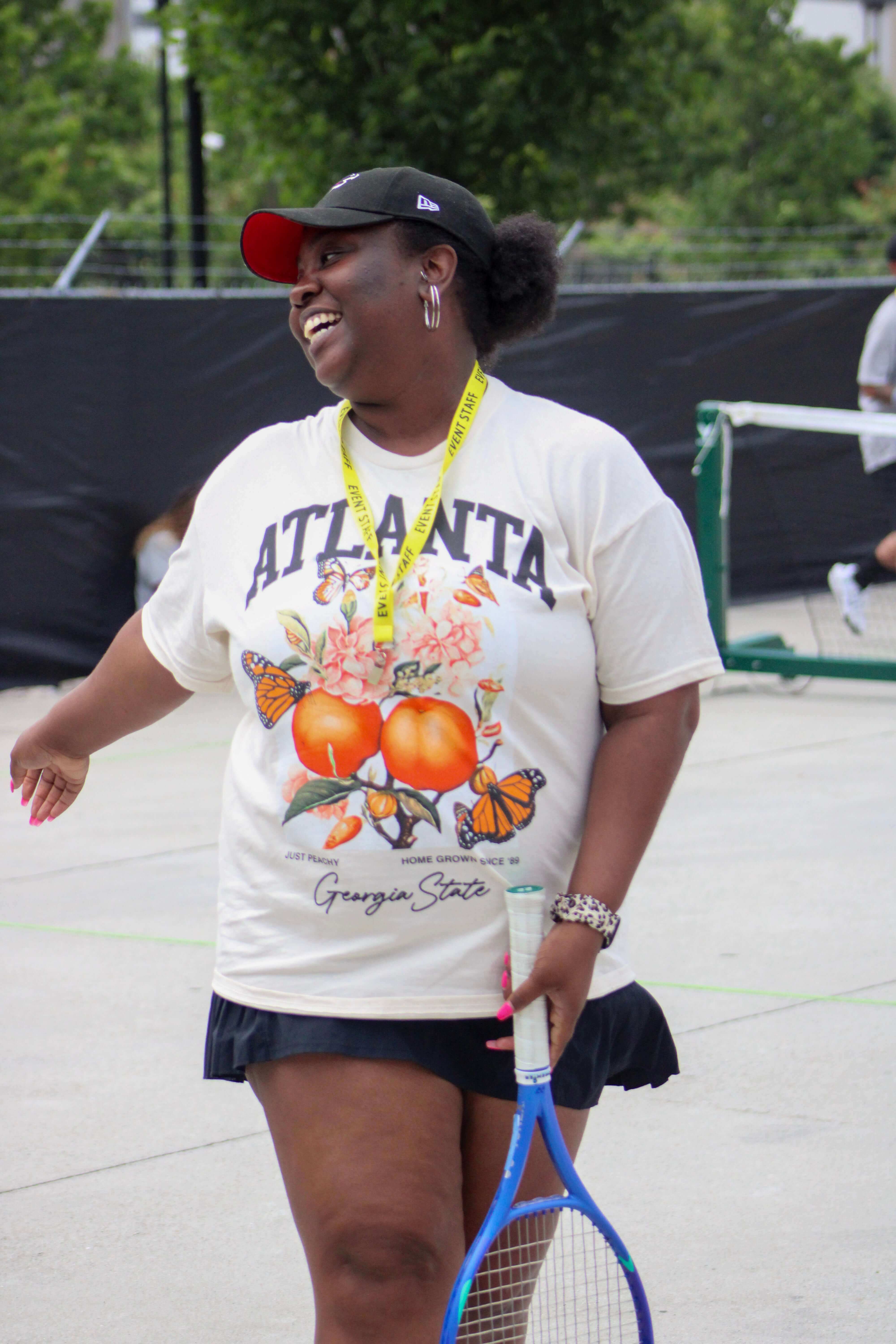 women walking a tennis racquet