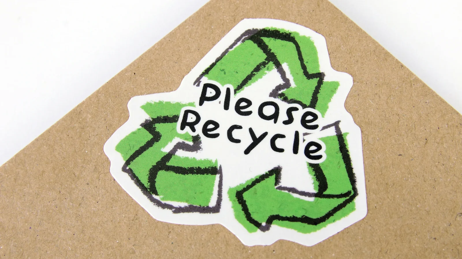 Recycling symbol sticker with "Please Recycle" text on cardboard packaging.