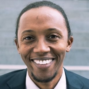 a close up of a white tiger near a building