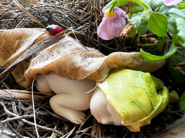 garden ornament of baby sleeping