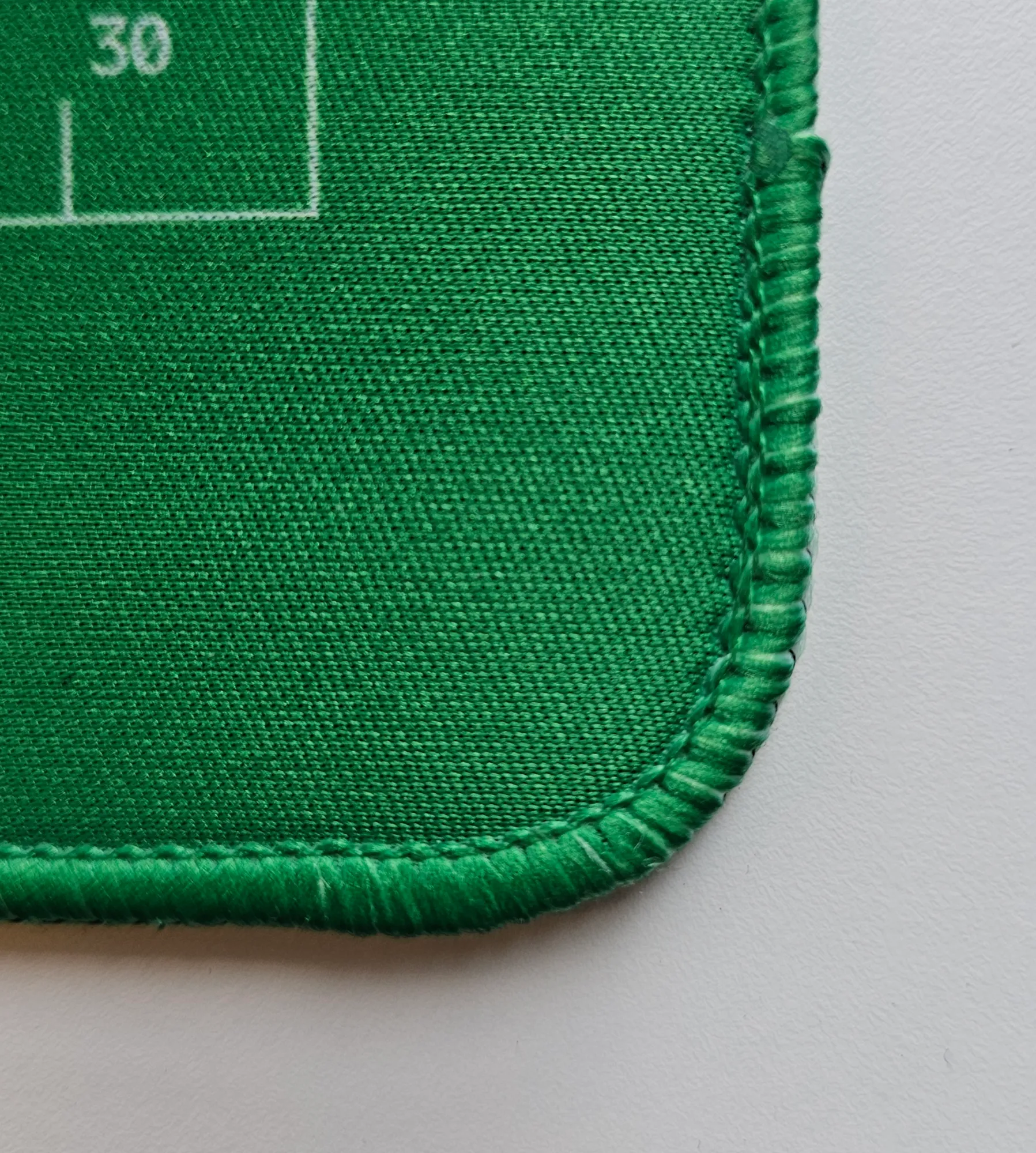 Close-up of the stitched green edge