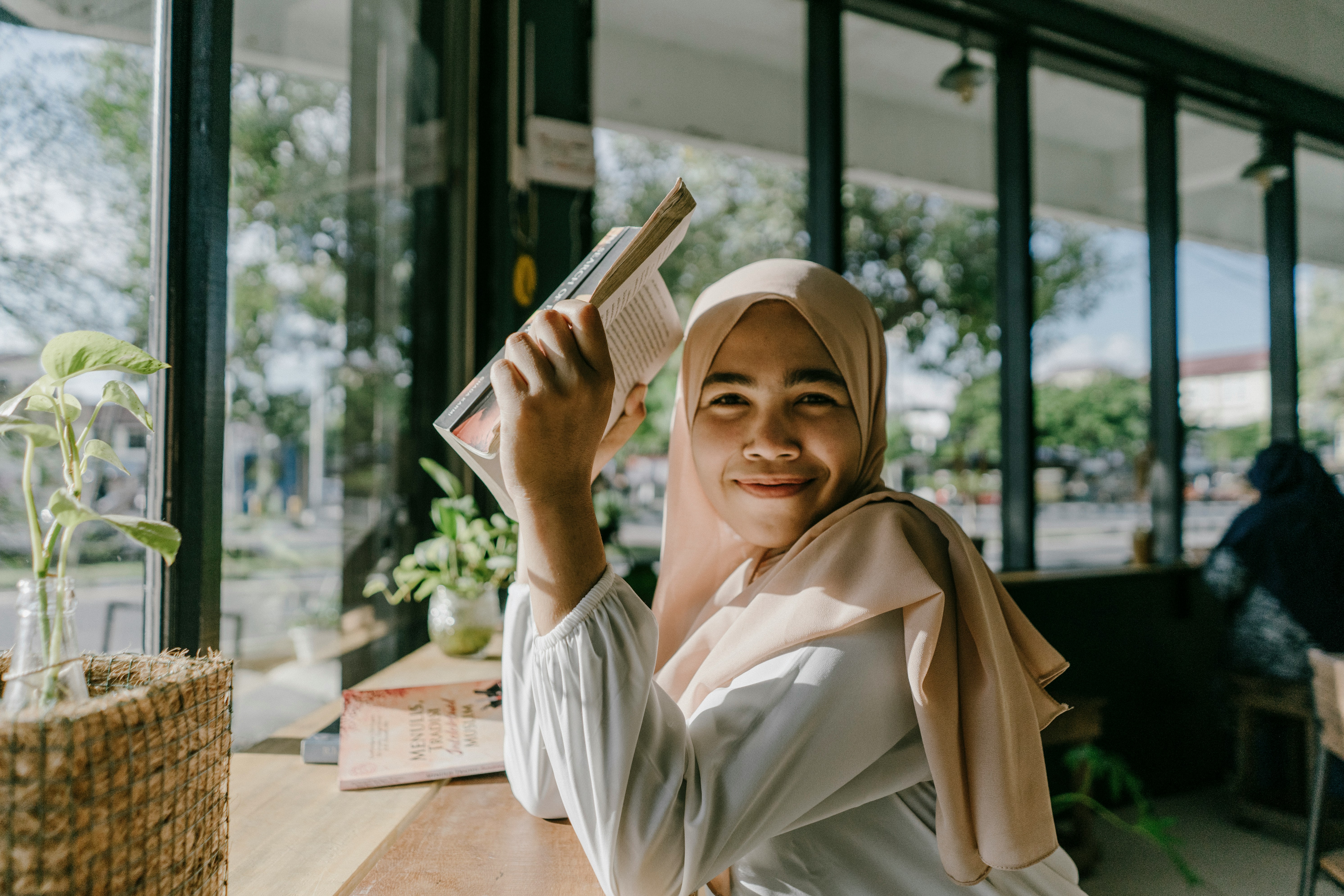 woman hijab with a book - How To Glow Up Before School