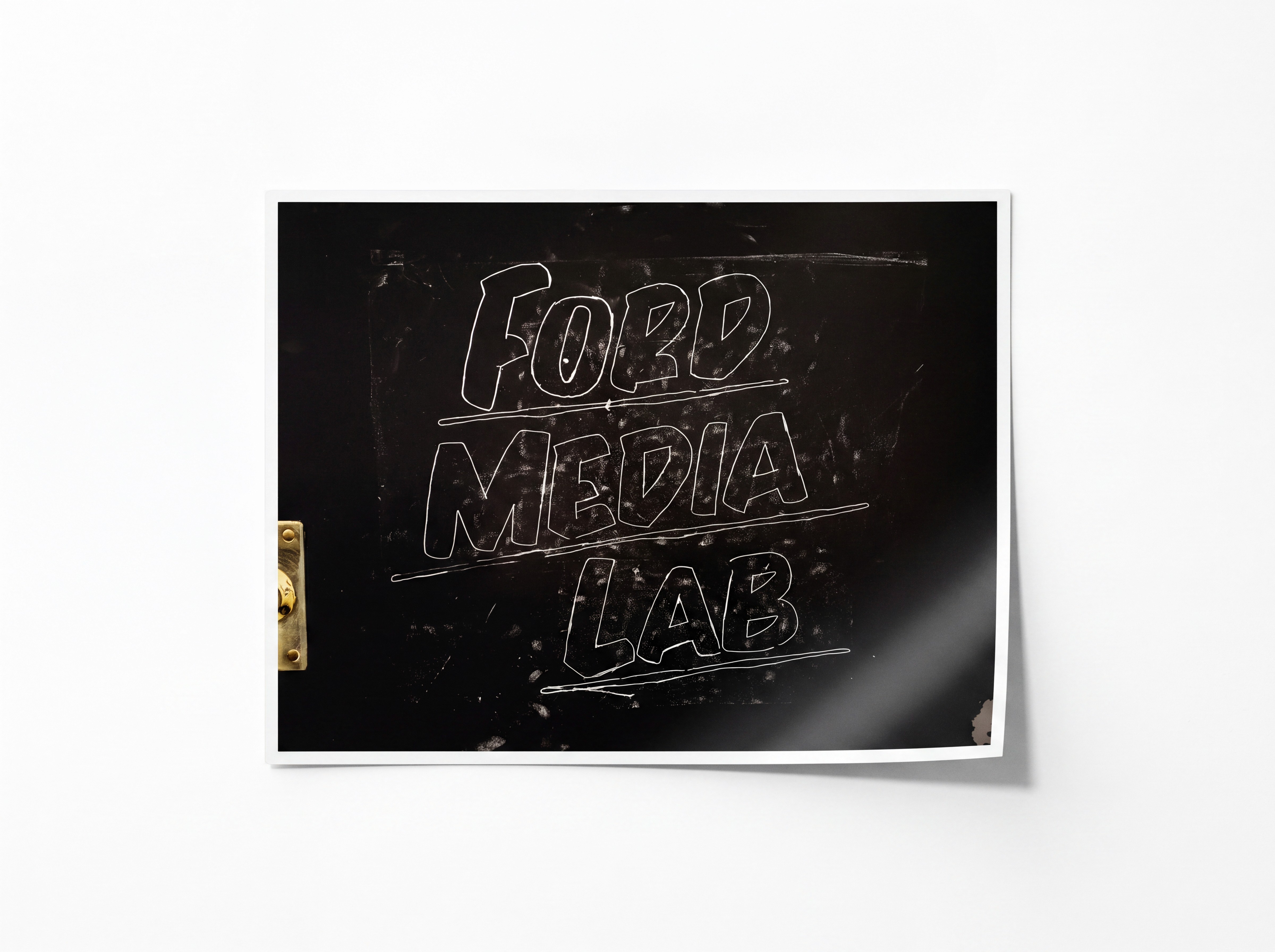 The original Ford Media Lab studio door in Greenpoint, Brooklyn: the studio name hand-chalked in outline by Baron Von Fancy on the black-painted door, 2019.