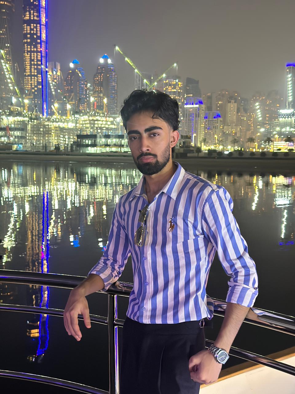 Nischal Poudel professional photo in a yacht looking confiendly at the camera with skyline view