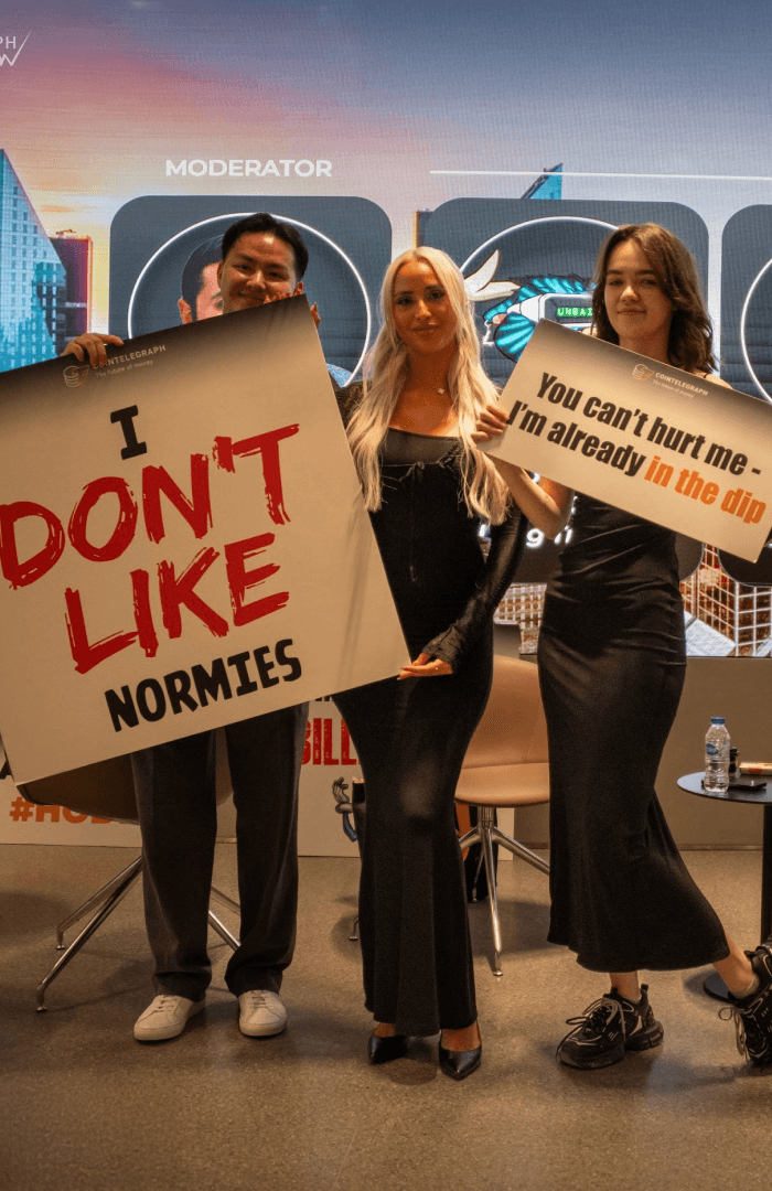 A woman in a striped shirt holds a credit card while using a laptop, bathed in warm sunlight in a cozy, modern setting.