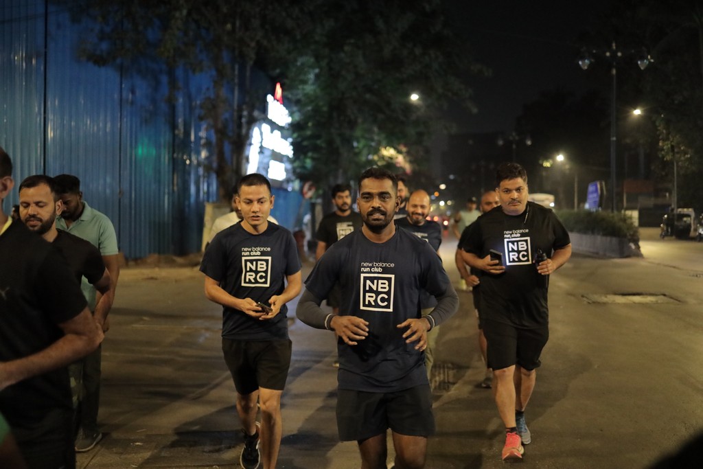 Two people stretching on yoga mats