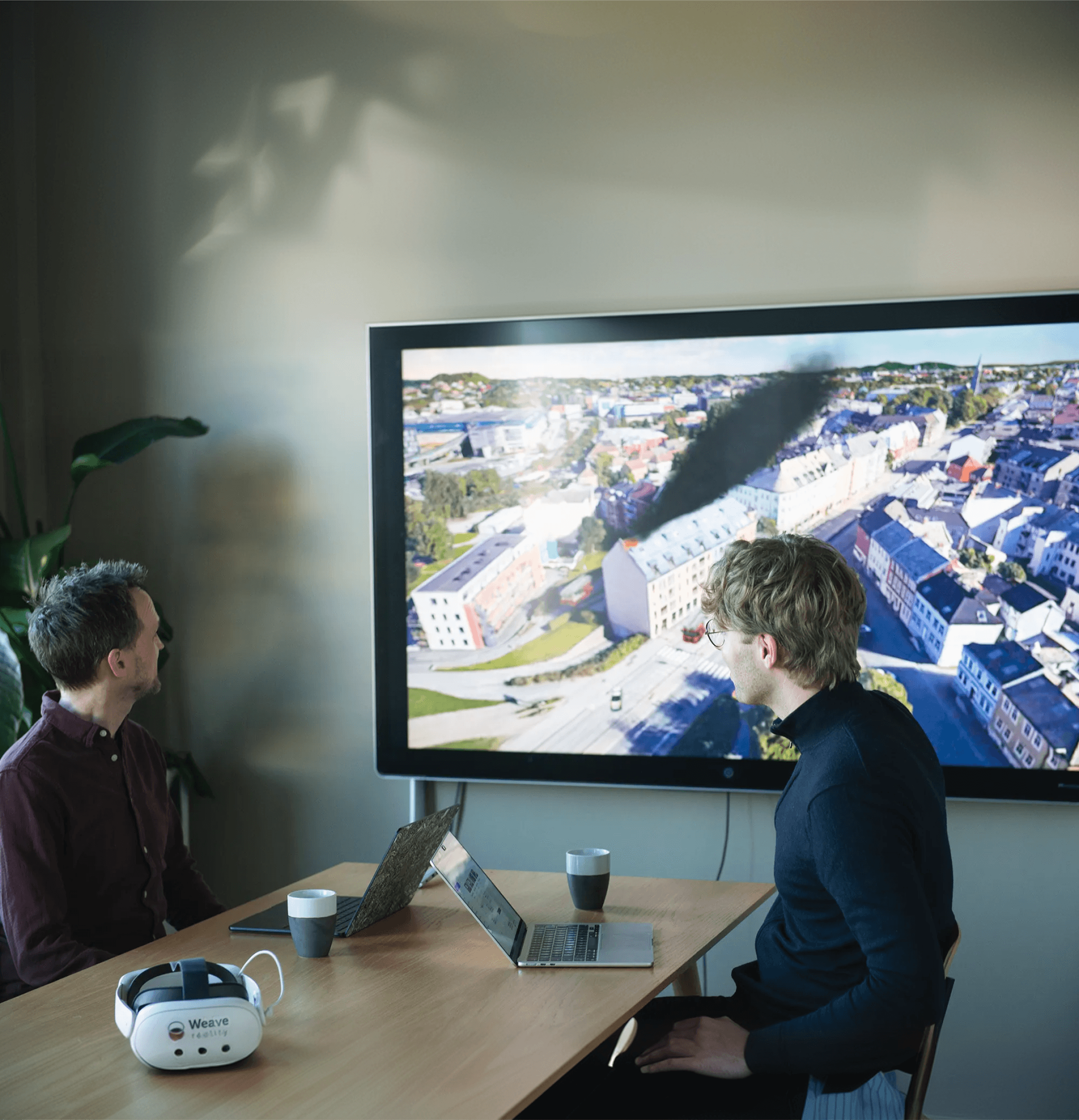 A diverse team collaborates around a table, analyzing documents and charts in a professional setting with a light green background.