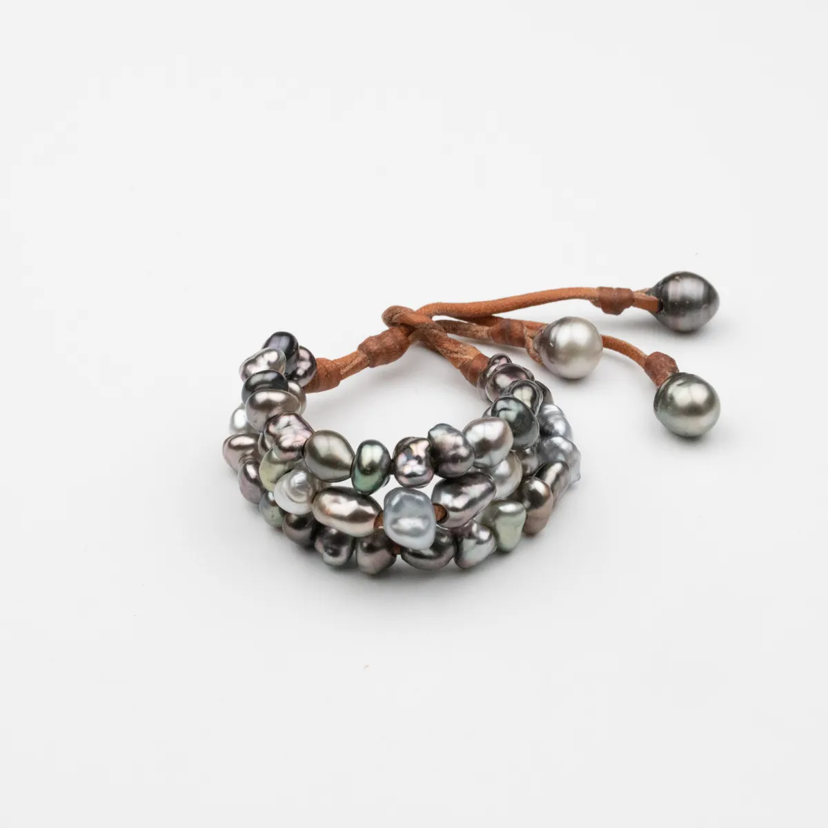 Keshi Pearl and baroque Tahitian Pearl three-strand leather bracelet with tan cord and pearl-tipped closure — Manos de Oro Saint Barth