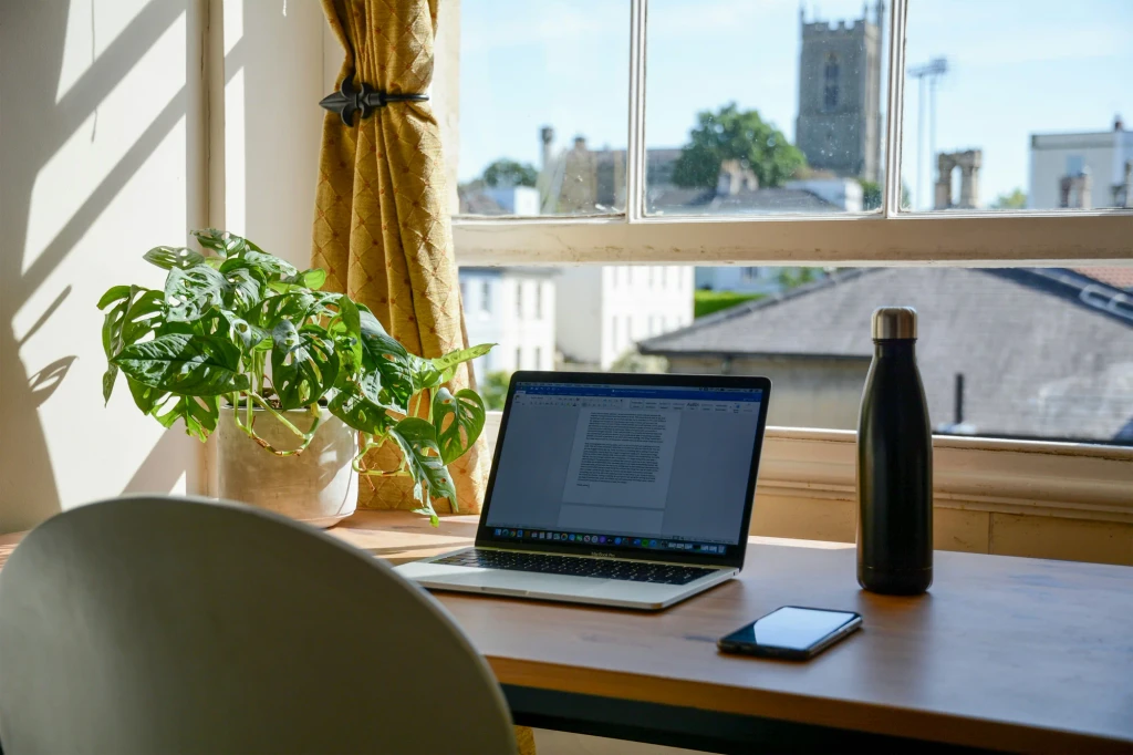 Home office desk with laptop planner and productivity tools