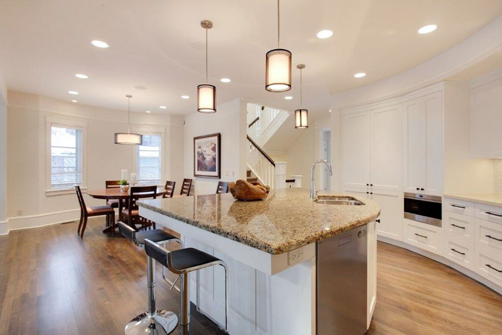 Image of Luxury kitchen design with island, granite countertops, and white cabinetry by KHD Homes interior design experts.