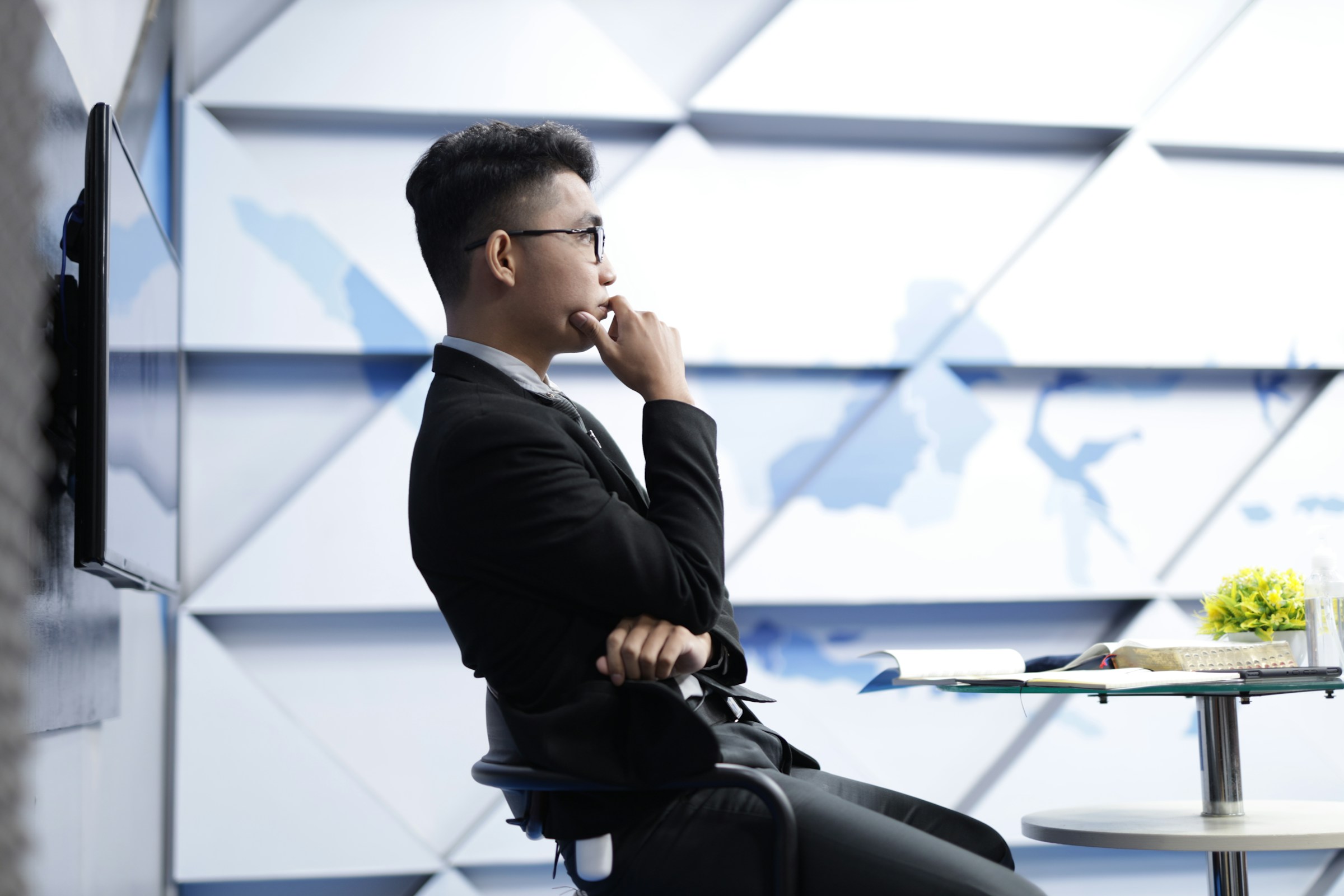 man thinking sitting on a chair - Product Photography Pricing 