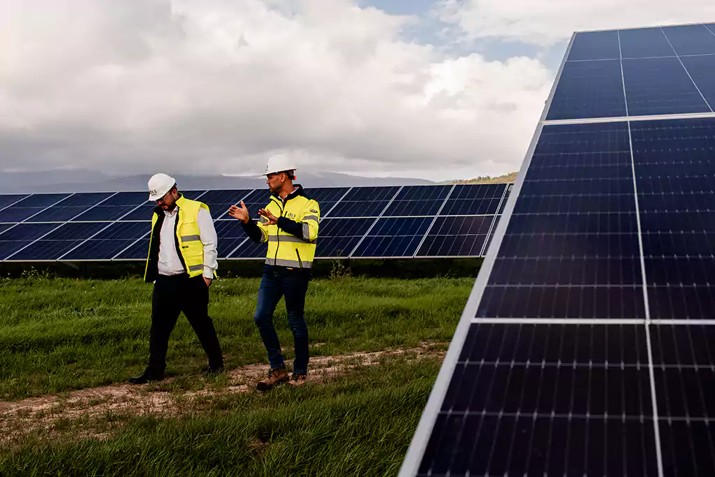 Technician in safety gear working on a solar panel