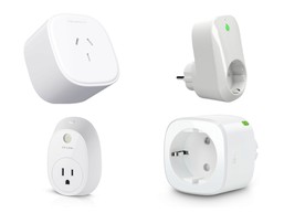 A smart plug in a wall outlet with a phone showing energy usage