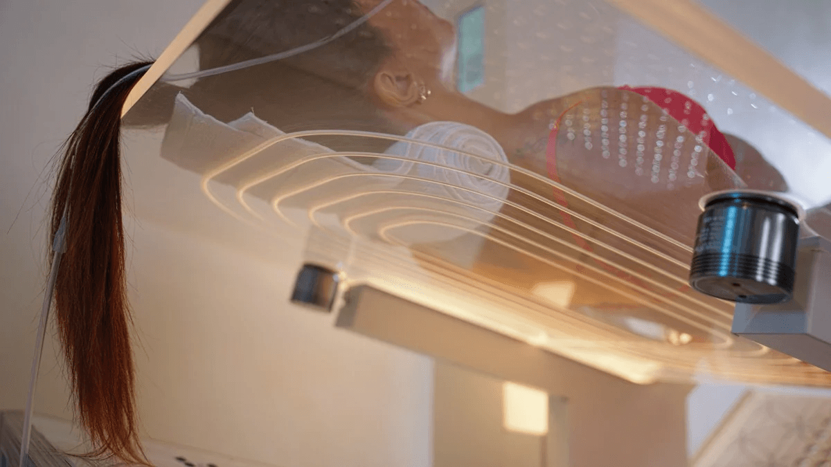 a woman sitting on a yoga mat in a room