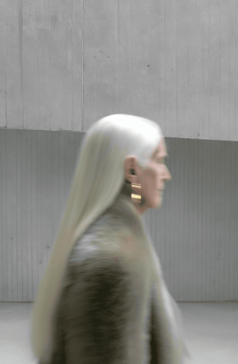 women with white hair posing towards right