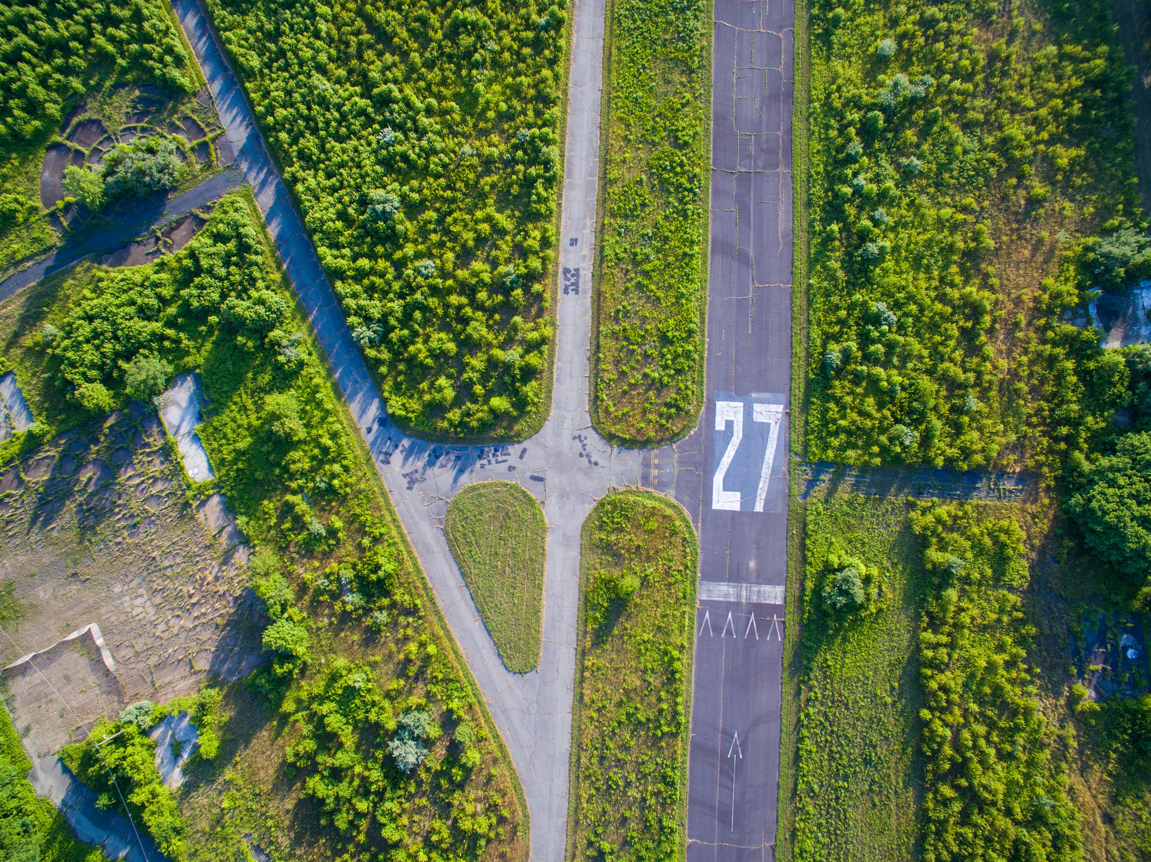 aerial photography of person trimming sports field during day