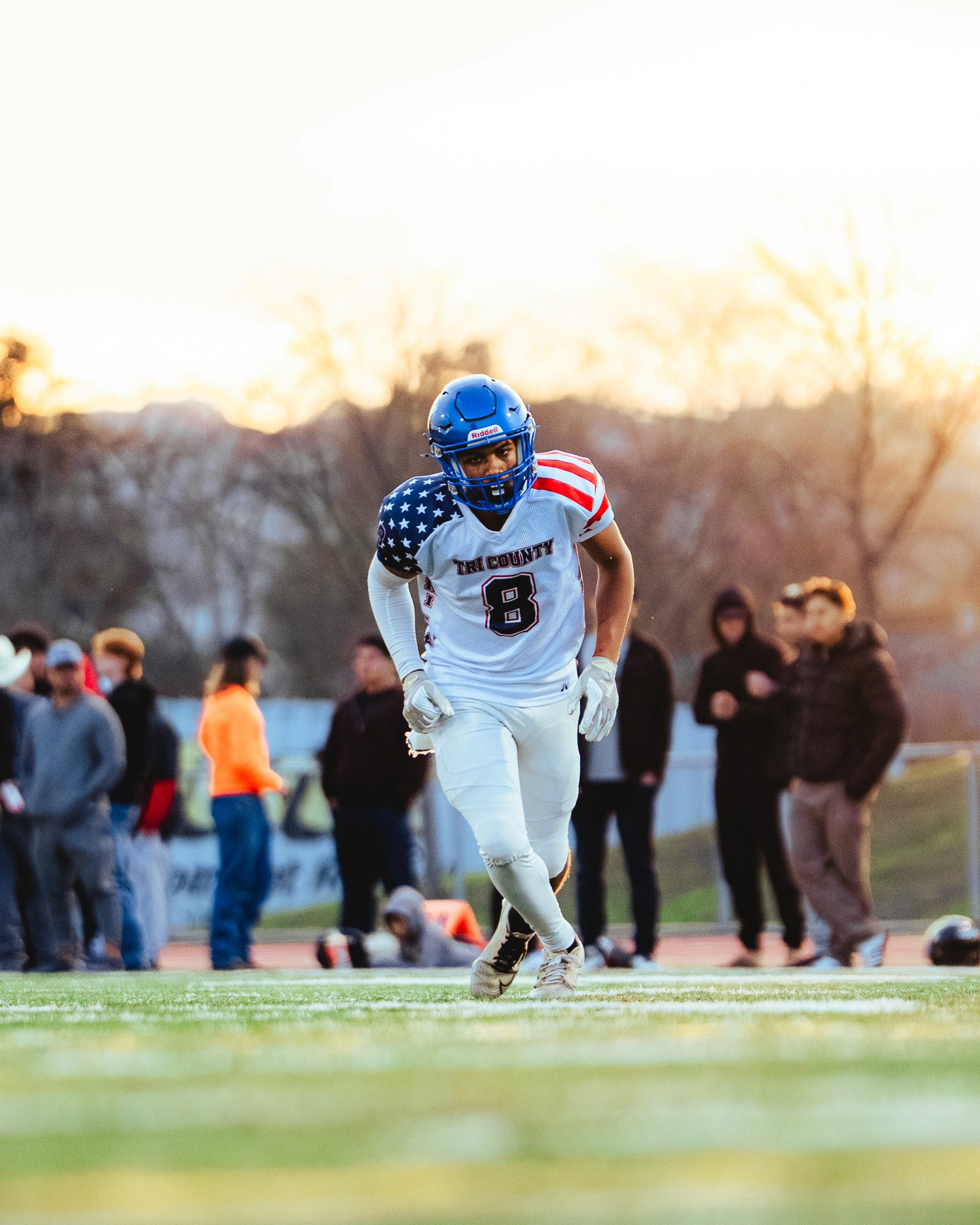A black and white profile portrait of a person with long hair, accented by sparkling, glittery light effects throughout the frame.