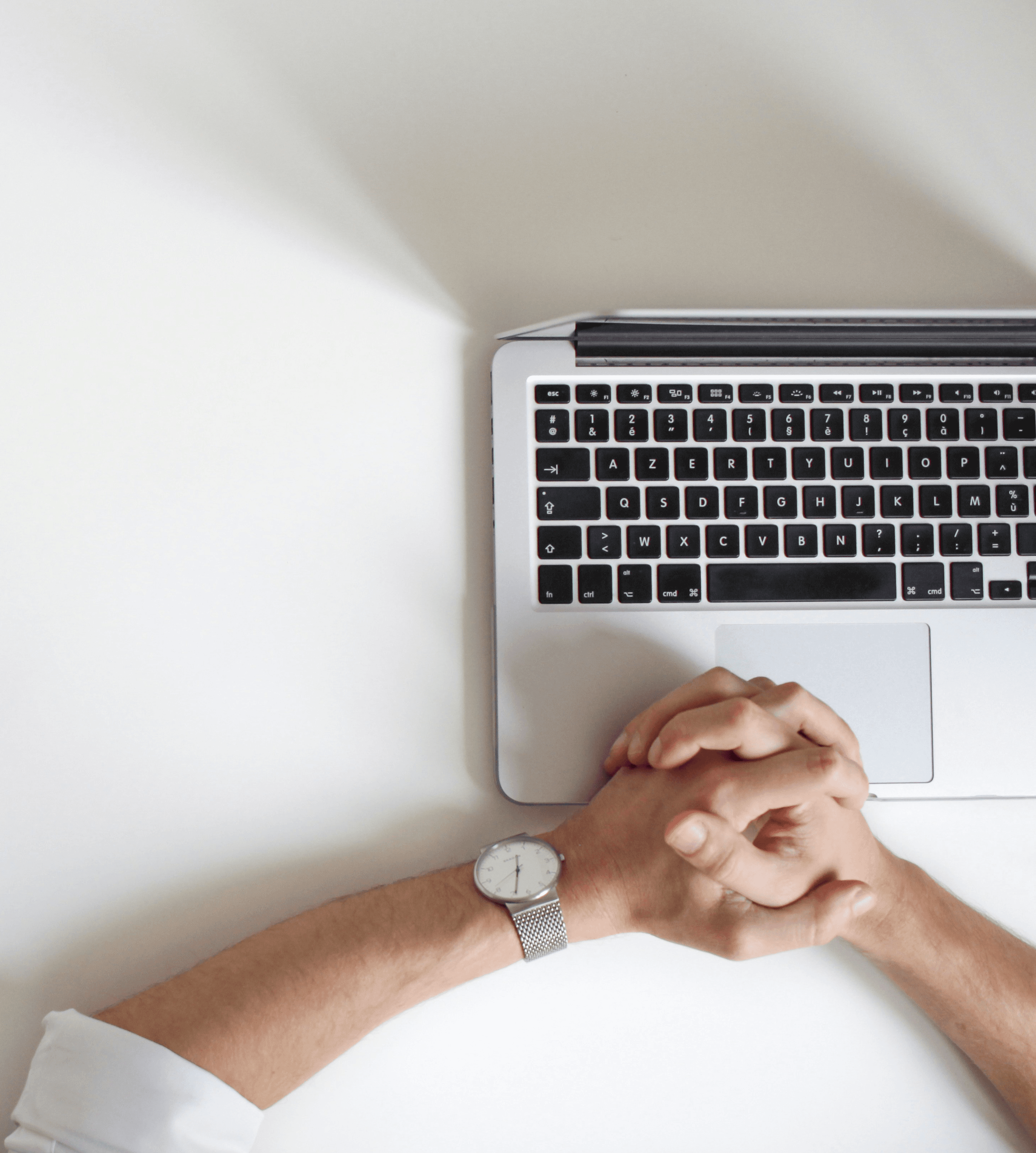 person wearing watch near laptop