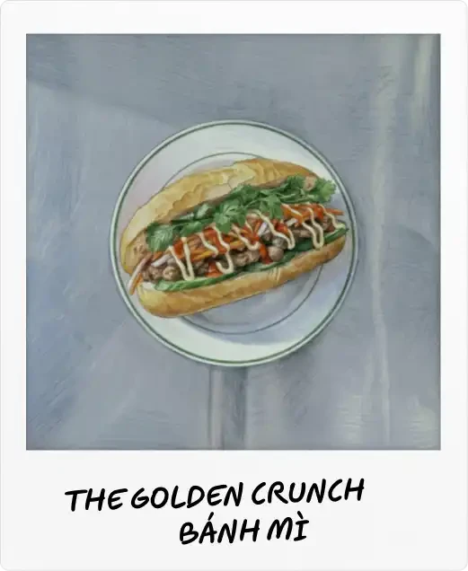 Pho Street Eats Polaroid captioned "The Golden Crunch bánh mì": a filled baguette with coriander, chilli and mayo on a plate.